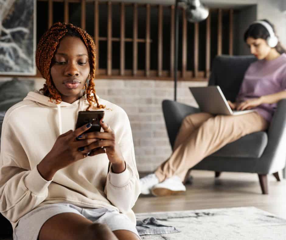 An image depicting two people using productivity apps on laptop and smartphone symbolizing the concept of leveraging technology for enhanced efficiency and time management